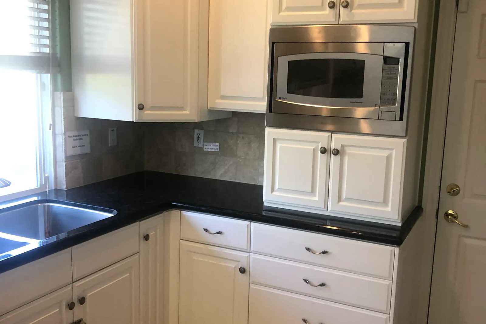 Sprayed kitchen cabinet refinish by AL's Quality